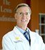 Doctor in white coat smiling confidently